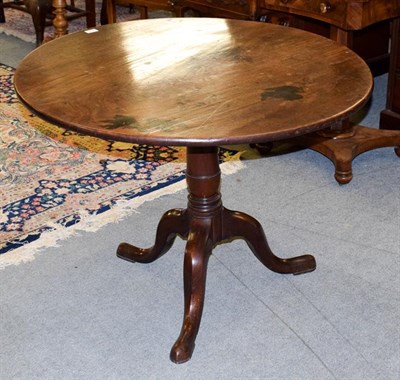 Lot 1164 - A Georgian mahogany tilt-top tripod table, with one piece top, 97cm diameter by 71cm high