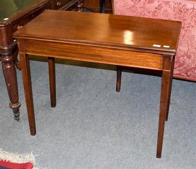 Lot 1166 - A 19th century mahogany fold over tea table, the moulded rectangular top over a plain frieze,...
