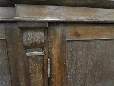 Lot 1174 - A Victorian mahogany breakfront sideboard with marble top, with panelled doors and square...