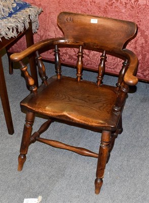 Lot 1175 - An early 19th century ash and elm elbow chair / captains chair