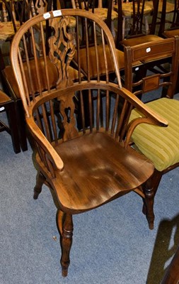Lot 1181 - A 20th century elm Windsor armchair with shaped seat and crinoline stretcher