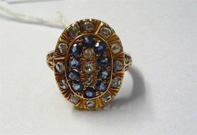 Lot 445 - A Diamond and Sapphire Cluster Ring, circa 1890, the oval head with old cut diamonds within a...