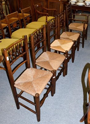 Lot 1183 - A set of five 19th century ash spindle-back kitchen chairs, with rush seats and including a...