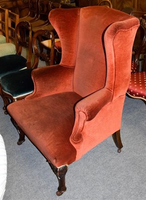 Lot 1190 - A 19th century carved walnut and upholstered wingback armchair