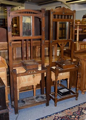 Lot 1194 - Two 1940's oak hallstands, both incorporating a mirror and glove box, largest 67cm by 24cm by 183cm