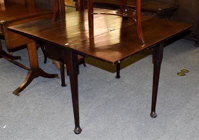 Lot 1195 - A George II mahogany drop-leaf dining table, on plain supports and pad feet, 112cm (open) by...