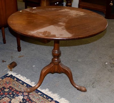 Lot 1198 - A George III mahogany tilt-top tripod table, 93cm diameter by 75cm high