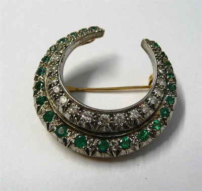 Lot 447 - An Emerald and Diamond Crescent Brooch, a row of graduated emeralds with an inner row of...