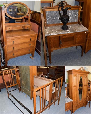 Lot 1205 - An early 20th century oak three piece bedroom suite; comprising a marble top washstand,...