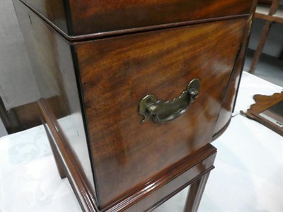 Lot 1207 - A George III mahogany cellarette on stand, inlaid, with bronze handles and raised on reeded...