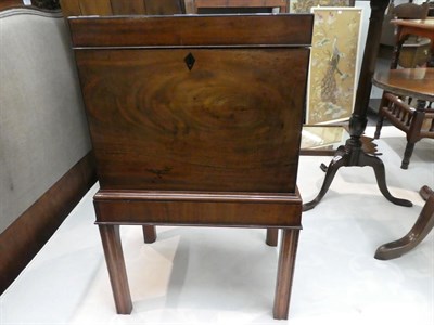 Lot 1207 - A George III mahogany cellarette on stand, inlaid, with bronze handles and raised on reeded...