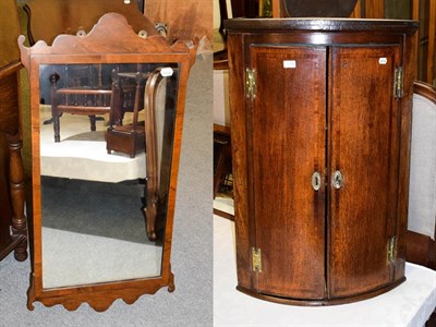 Lot 1208 - A Georgian mahogany hanging bow-front corner cupboard, 65cm by 98cm high together with a walnut...