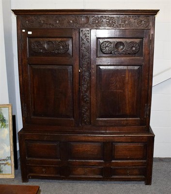 Lot 1216 - Period oak linen cabinet of pegged construction and raised on three drawer base, 148cm by 54cm...