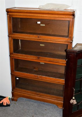 Lot 1220 - A Globe Wernicke mahogany four-tier bookcase, labelled, 87cm by 27cm by 142cm high