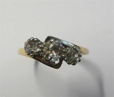 Lot 449 - A Diamond Three Stone Ring, the graduated old cut diamonds in a white claw twist setting, to a...