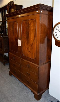 Lot 1223 - An early 19th century mahogany dwarf linen press, panelled top section raised over a chest base...