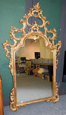 Lot 1230 - A carved and gilt composition Rococo style mirror decorated with scrolling acanthus leaves,...