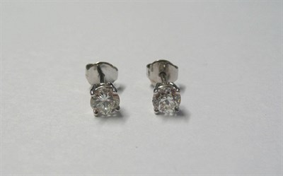 Lot 450 - A Pair of 18 Carat White Gold Diamond Solitaire Stud Earrings, the round brilliant cut diamonds...