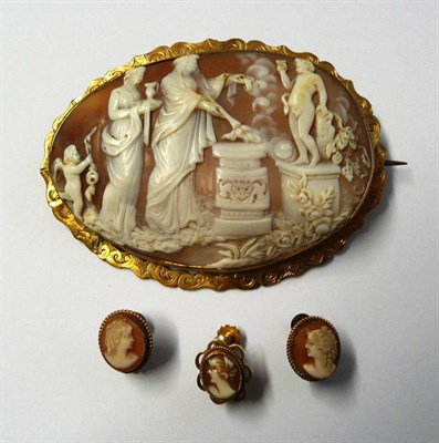 Lot 451 - A Large Cameo Brooch, the oval shell carved to depict a classical scene, within an engraved...