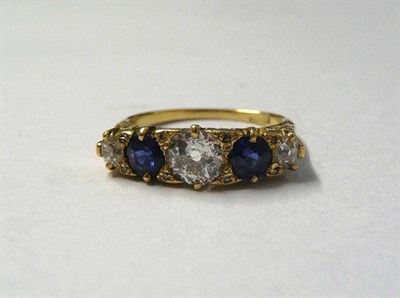 Lot 462 - A Diamond and Sapphire Five Stone Ring, three old cut diamonds alternate with two old cut...