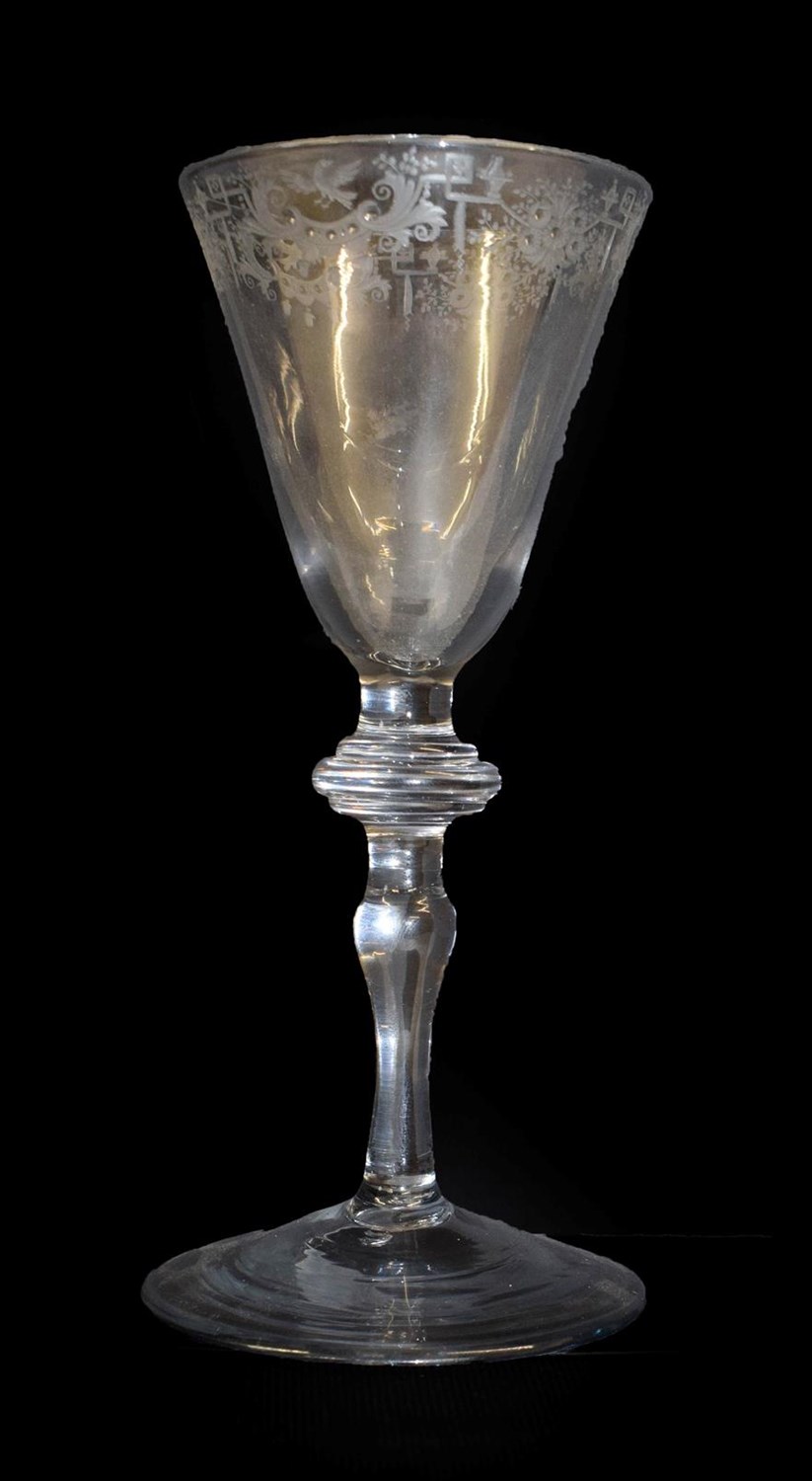 Lot 2 - A Light Baluster Wine Glass, circa 1740, the rounded funnel bowl engraved with a border of...