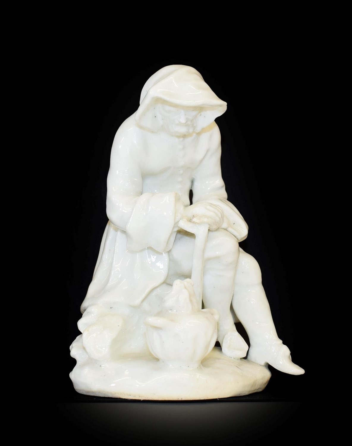 Lot 6 - A Bow Porcelain Figure of Winter, circa 1755, from the Rustic Seasons, modelled as a bearded seated