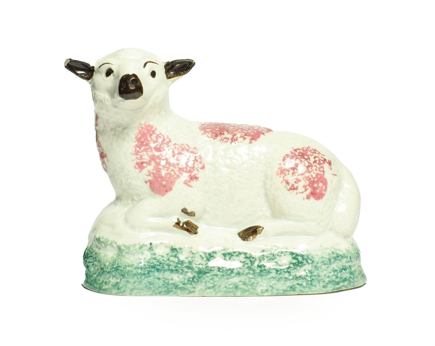Lot 18 - A Pratt Type Figure of a Sheep, circa 1800, recumbent with puce sponged markings on a green...