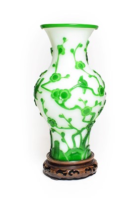 Lot 67 - A Peking Green Overlay Opaque White Glass Baluster Vase, late 19th/early 20th century, carved...