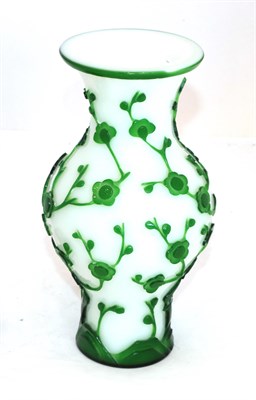 Lot 67 - A Peking Green Overlay Opaque White Glass Baluster Vase, late 19th/early 20th century, carved...