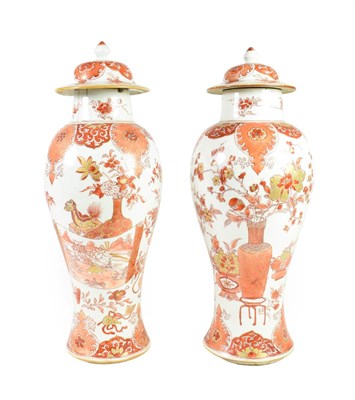 Lot 81 - A Pair of Chinese Porcelain Baluster Vases and Covers, Yongzheng/Qianlong, painted in iron red...