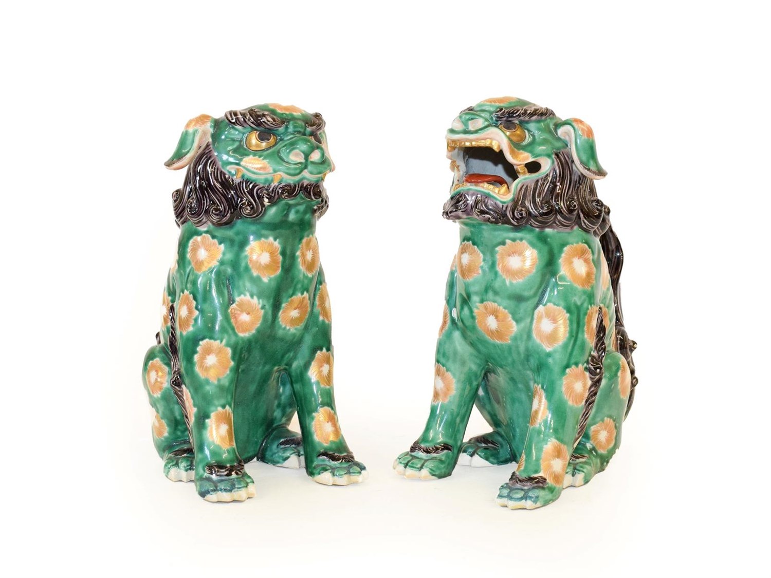 Lot 85 - A Pair of Chinese Porcelain Temple Guardians, in 18th century style, modelled as seated lion...