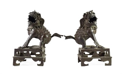 Lot 99 - A Pair of Chinese Bronze Figures of Temple Guardians, 19th century, modelled as roaring lion...