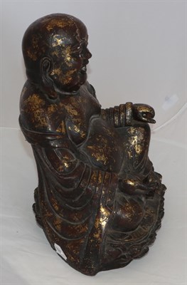 Lot 100 - A Chinese Lacquered and Gilt Bronze Figure of Putai, in Ming style, the corpulent figure seated...