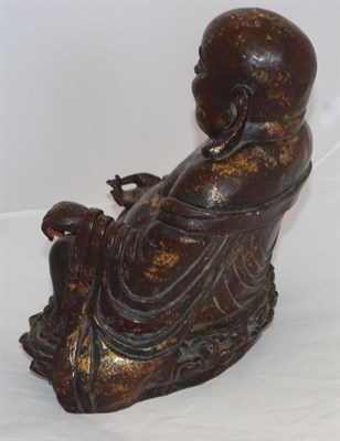Lot 100 - A Chinese Lacquered and Gilt Bronze Figure of Putai, in Ming style, the corpulent figure seated...