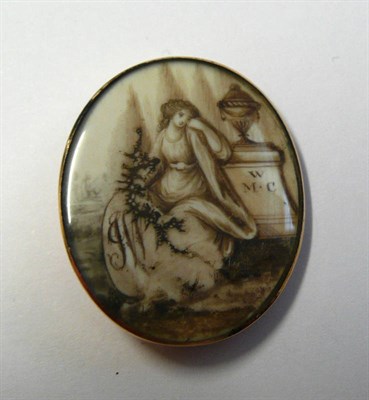 Lot 481 - A Late 18th Century Mourning Brooch, the oval ivory panel sepia painted to depict a wistful...