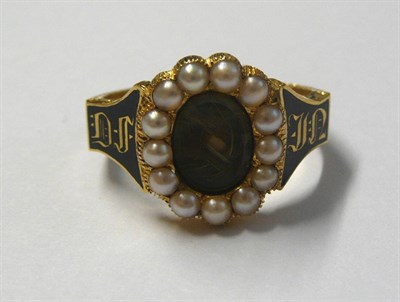 Lot 482 - An Early Victorian 18 Carat Gold Mourning Ring, a central oval locket panel encloses plaited...