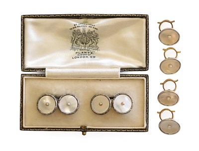 Lot 151 - ~ A Set of Four Mother-of-Pearl Buttons, a seed pearl placed upon a circular mother-of-pearl plaque