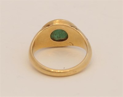Lot 154 - ~ A Green Glass Signet Ring, the oval intaglio seal, inset into a yellow tapered shank, finger size