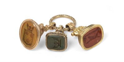 Lot 165 - ~ Three Gilt-Metal Mounted Fob-Seals, Mid 19th Century, the matrix of each carved, one with the...