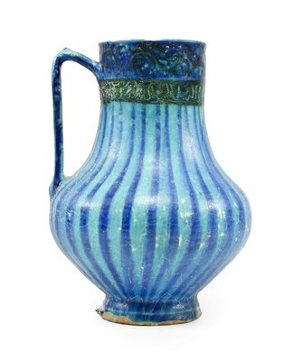 Lot 280 - A Kashan Pottery Ewer, 13th century, of baluster form with strap handle, painted in black with band
