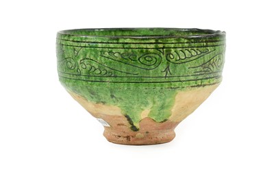 Lot 282 - A Garrus Green Glazed Earthenware Bowl, 12th/13th century, carved and incised through the black...