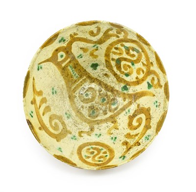 Lot 284 - A Slip Painted Earthenware Bowl, probably Tashkent, 13th century, painted in green and ochre with a