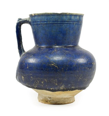 Lot 289 - An Iranian Blue Glazed Ewer, 12th/13th century, of ovoid form with angular handle, the slightly...