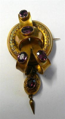 Lot 499 - A Victorian Knot Brooch, a polished knot set with oval cut foil backed garnets, with a filigree...