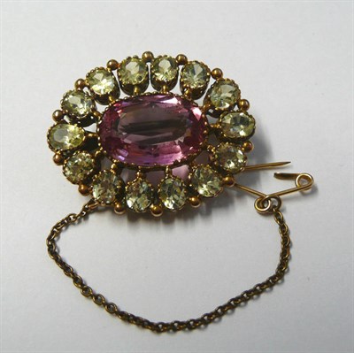 Lot 501 - A Mid 19th Century Cluster Brooch, the central pink topaz within a border of green old oval cut...