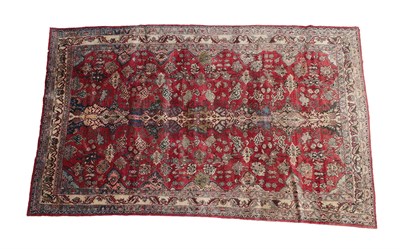 Lot 327 - North West Persian Carpet, circa 1950 The cherry red field of flowerheads and angular vines...