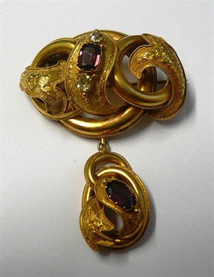 Lot 504 - A Victorian Garnet and Chrysoberyl Brooch, of loop form, with foliate decoration on a...