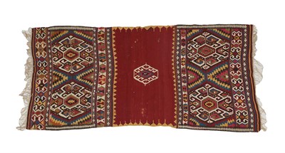 Lot 344 - West Anatolian Kilim, circa 1900 The madder field with a central hexagon flanked by saw tooth...