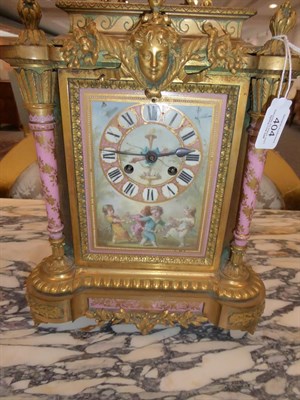 Lot 404 - A Gilt Metal Pink Porcelain Mounted Striking Mantel Clock, circa 1890, surmounted by a swan handled