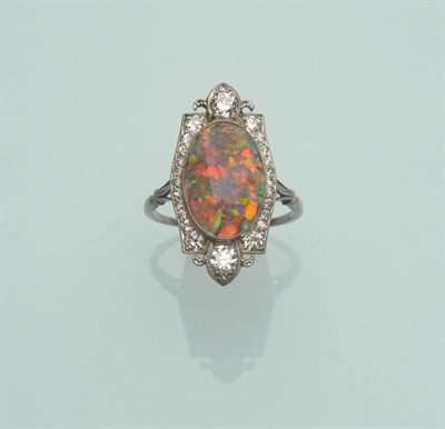 Lot 510 - An Art Deco Black Opal and Diamond Cluster Ring, the oval cabochon black opal within a shaped...